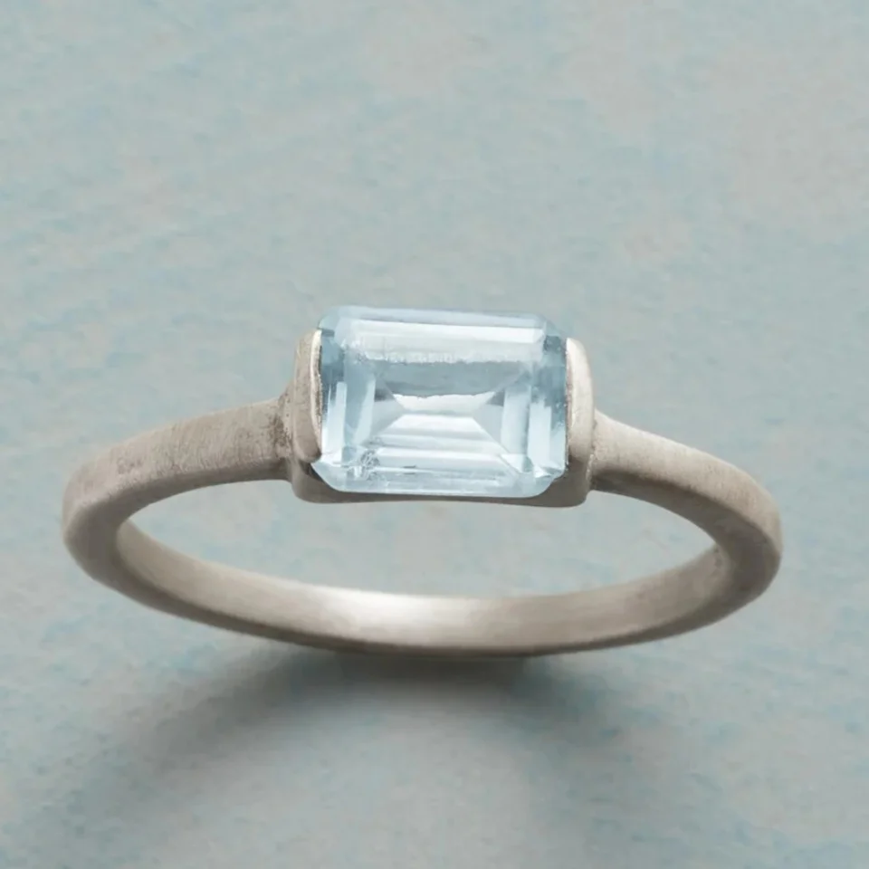 A vintage and minimalist copper material ring hand-set with light blue synthetic zircon by artisans