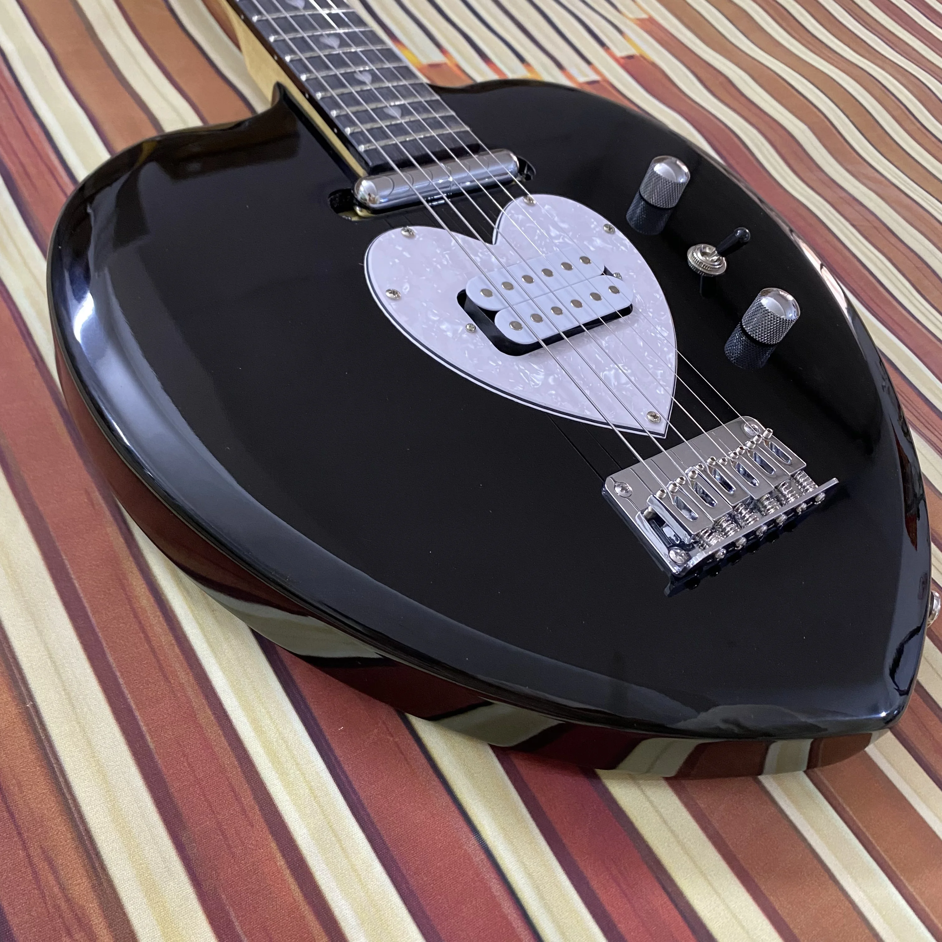 Vicers Guitarra elétrica requintada em forma de coração. Corpo em mogno. Fretboard de jacarandá. Pescoço de bordo. 22 trastes. Ferragens cromadas.