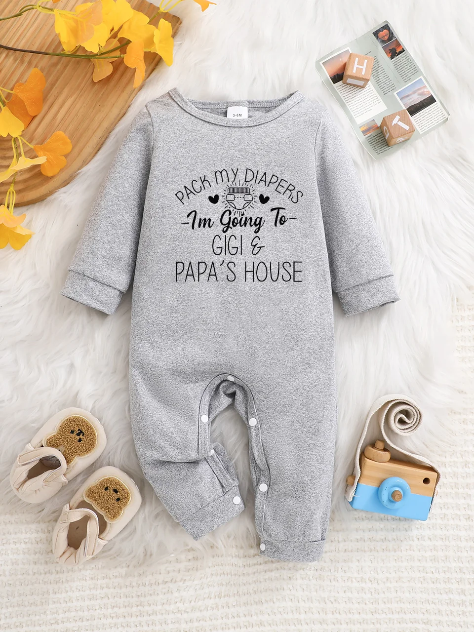 A baby long-sleeved onesie with interesting letter prints. It features a buttoned design for easy putting on and taking off