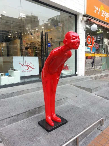 الحياة الحديثة الحجم الفن التجريدي الراتنج الشكل الأحمر القوس الراتنج الألياف الزجاجية رجل النحت الكرتون الراتنج ترحيب تمثال للبيع