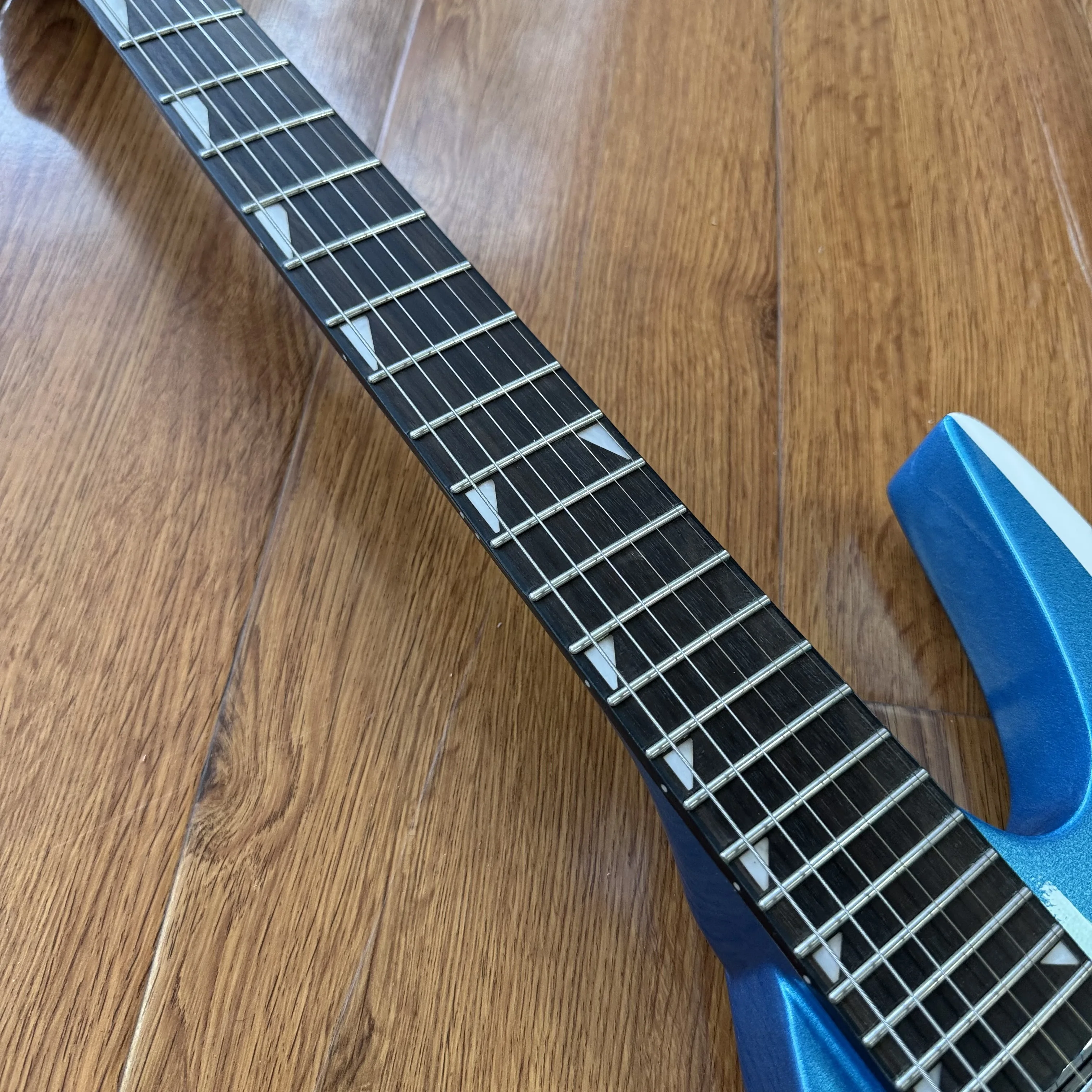 Electric Guitar Sharp Shark-Fin Body Contour Blue White Contrast Finish Highly Recognizable Space-Age Aesthetics Future Retro.