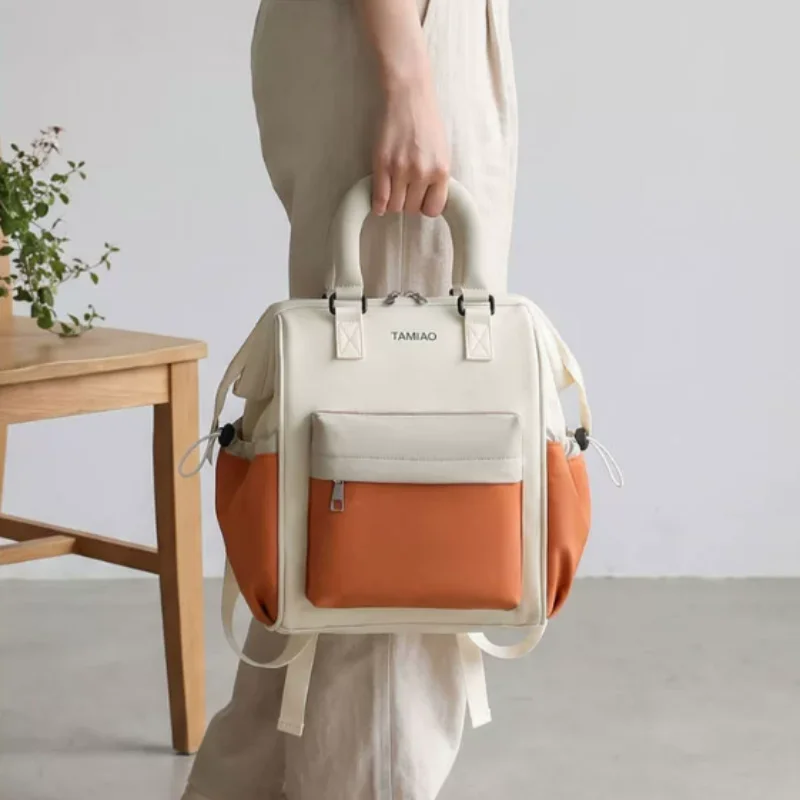 Mama Bag - A lightweight, small-sized hand-held and dual-shoulder baby carrying and storage bag for mother and baby outings.