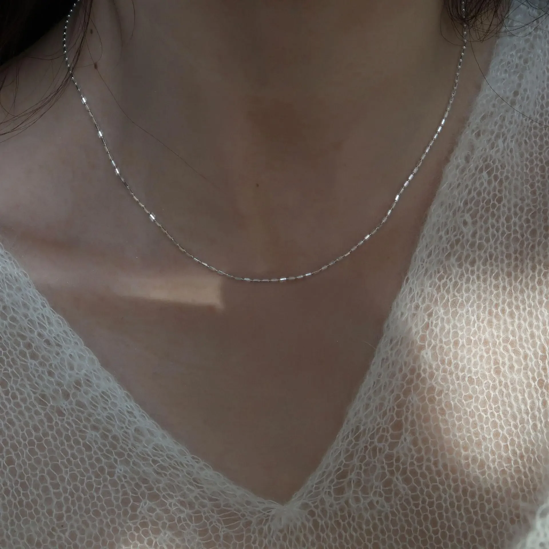 Minimalist geometric silver necklace crafted from 925 sterling silver featuring textured rice-grain chain design ideal for clavi