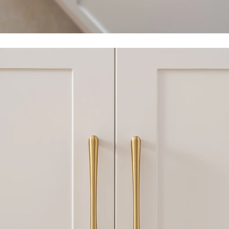Long brass pulls mounted on white wardrobe doors