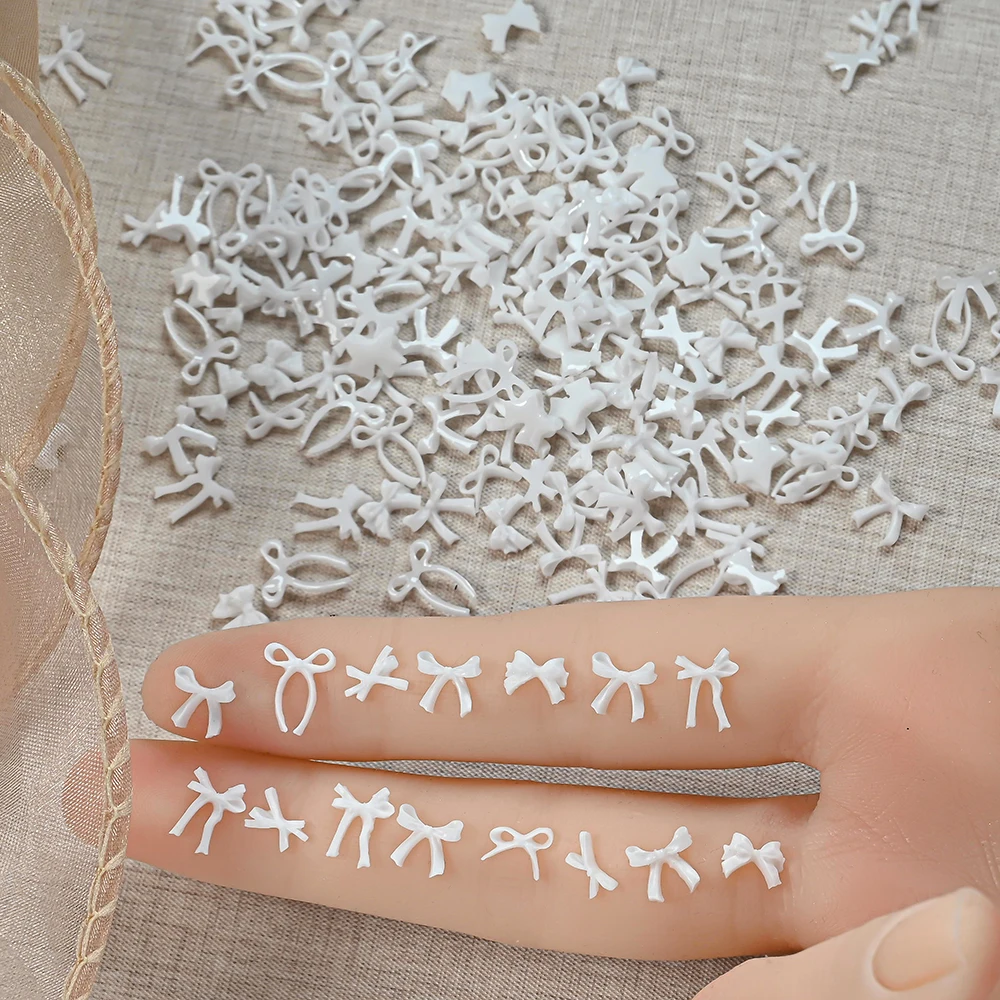 ชาร์มตกแต่งเล็บรูปโบว์สีขาวสไตล์มินิมอล 3 มิติ จำนวน 100 ชิ้น โบว์ริบบิ้นมินิแบบคละแบบสำหรับตกแต่งเล็บ DIY งานฝีมือ ชิ้นส่วนสำหรับทำเล็บ