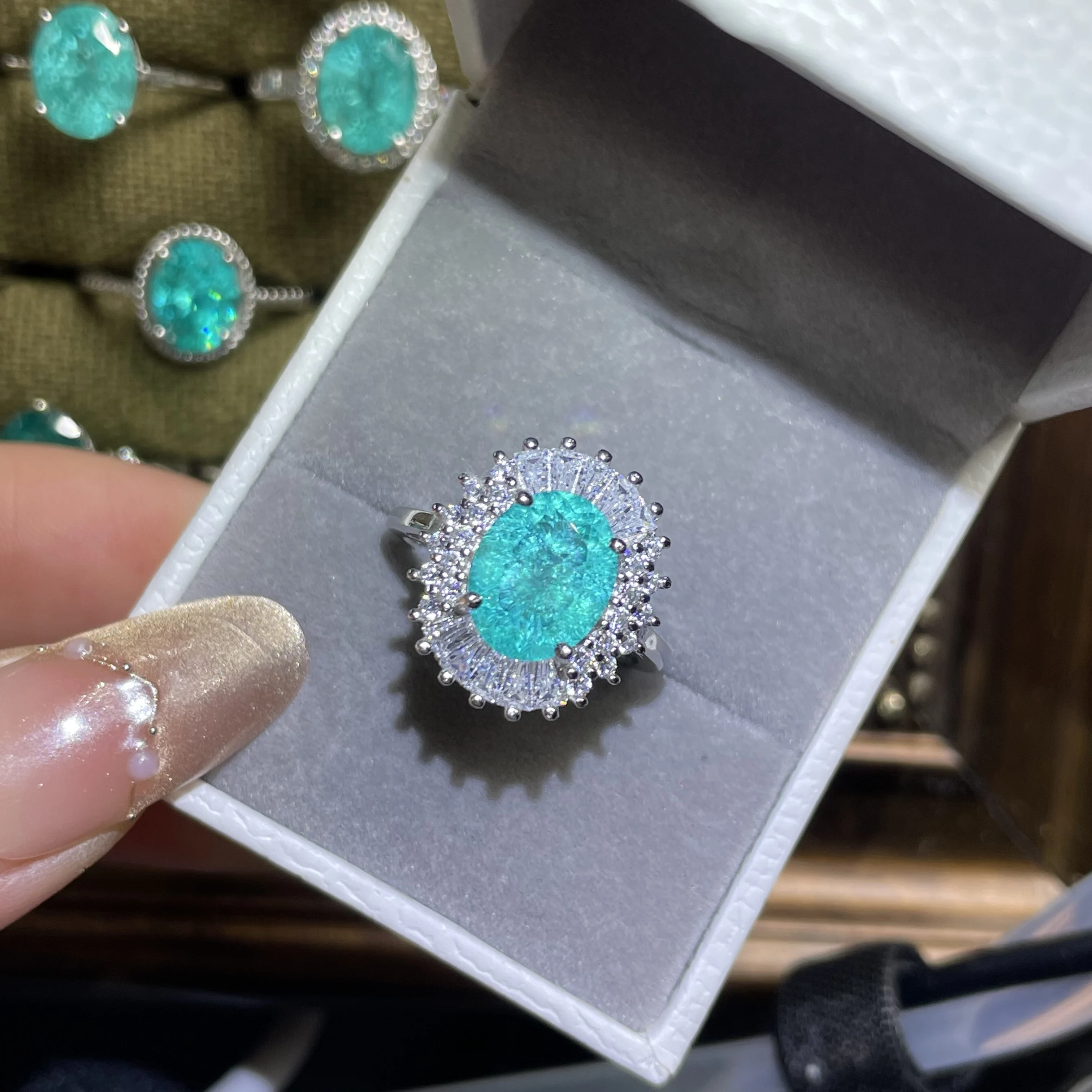 100%  A 6-carat neon blue Paraiba tourmaline gemstone, with ice cracks, paired with a 925 metal adjustable ring.