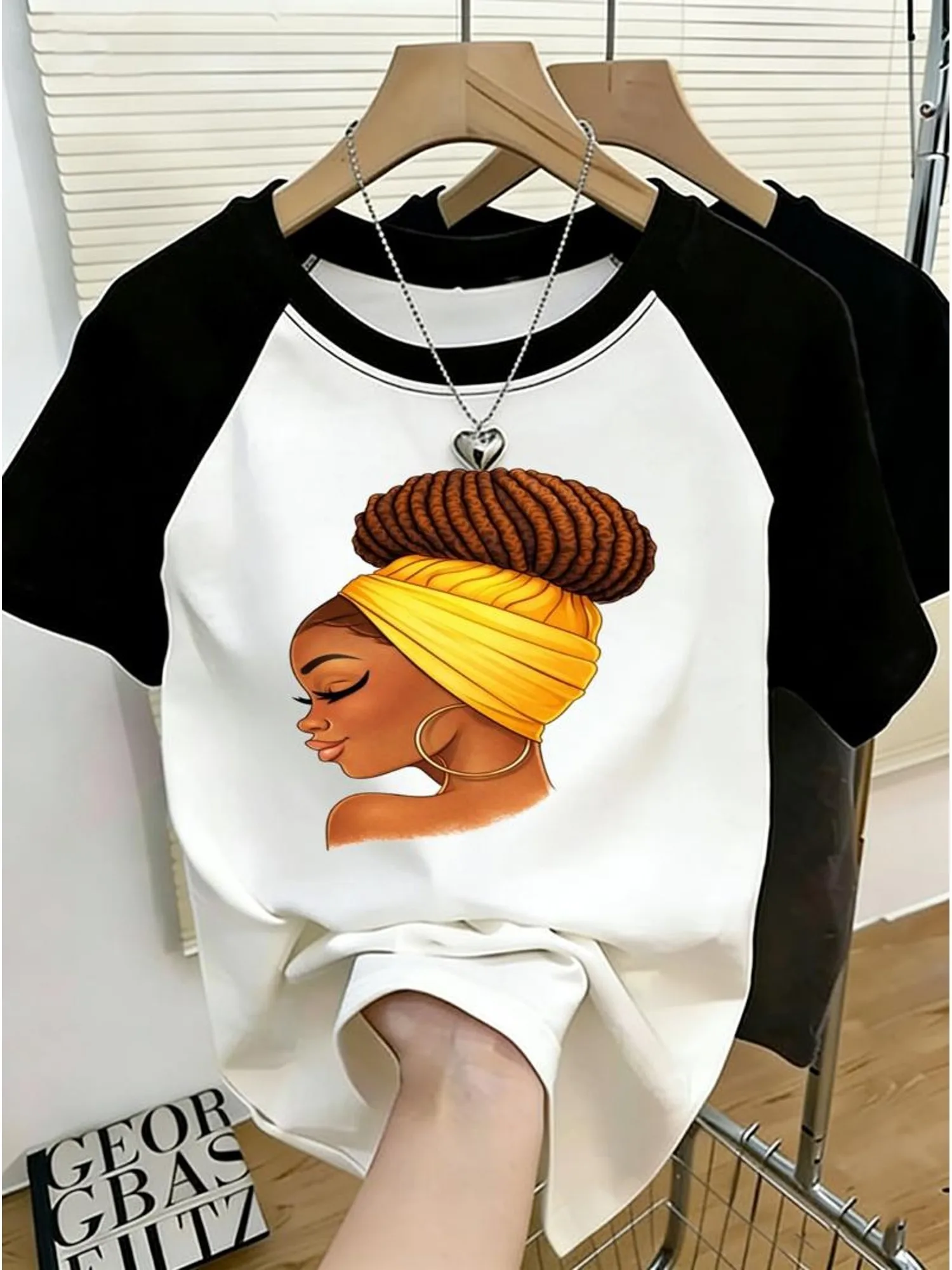 Round-Neck T-Shirt with Colorful Patchwork, Fashionable T-Shirt, White with Black Raglan Sleeves, Colorful Female Illustration Print, Material Options, Various Colors and Sizes Available, Stylish Design for Everyday Wear
