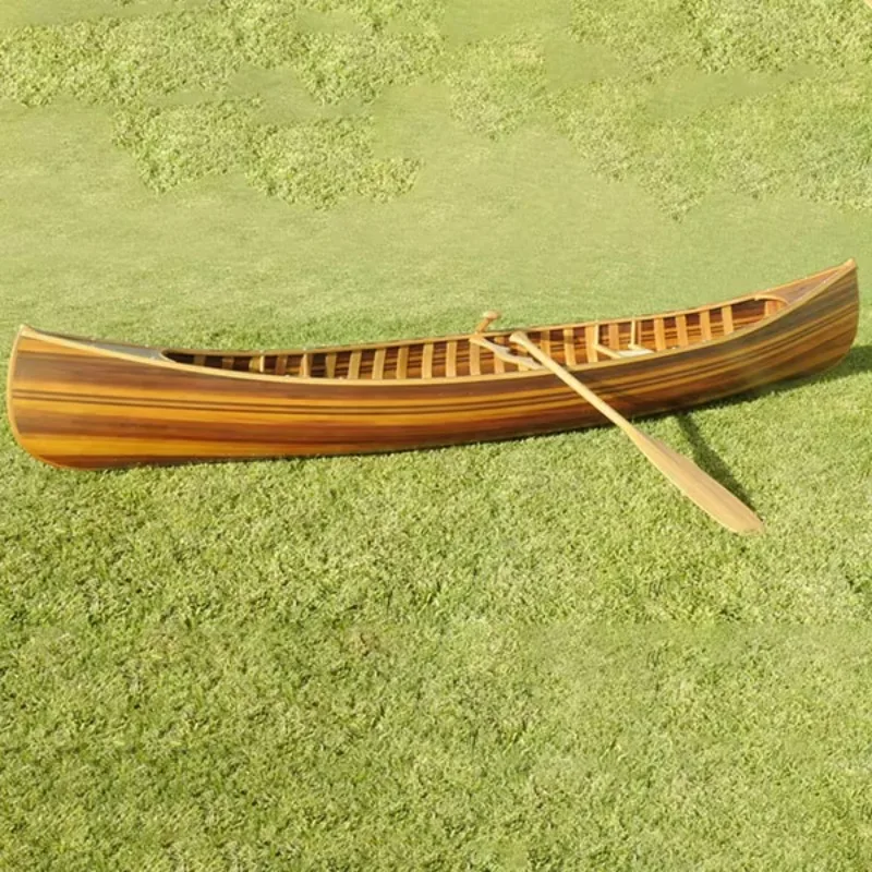 

Cedar strip canoe with curved bow and ribbed matte fiberglass hull lake paddle kayak