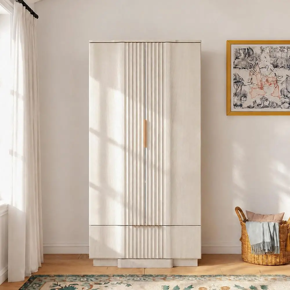 Interior view of fluted armoire showing top metal hanging rod and lower drawer