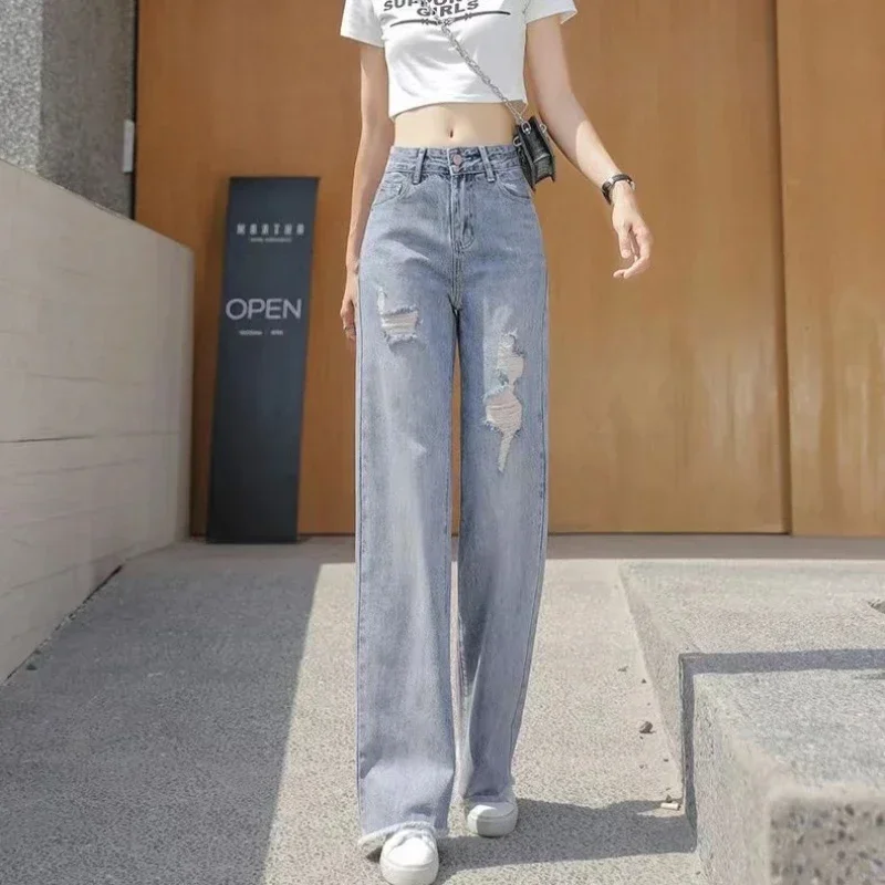 Celana panjang robek wanita, celana longgar kaki lebar dengan lubang Jeans dasar grosir Xxl Emo 2025 gaya Korea longgar celana koboi untuk wanita