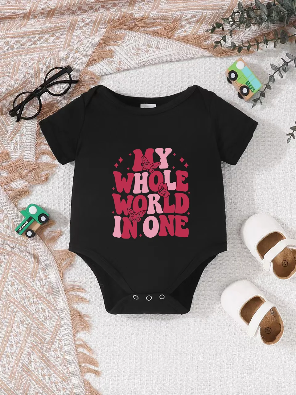 Playful letter-printed baby short-sleeve triangle bodysuit. Button closure for easy dressing, machine washable
