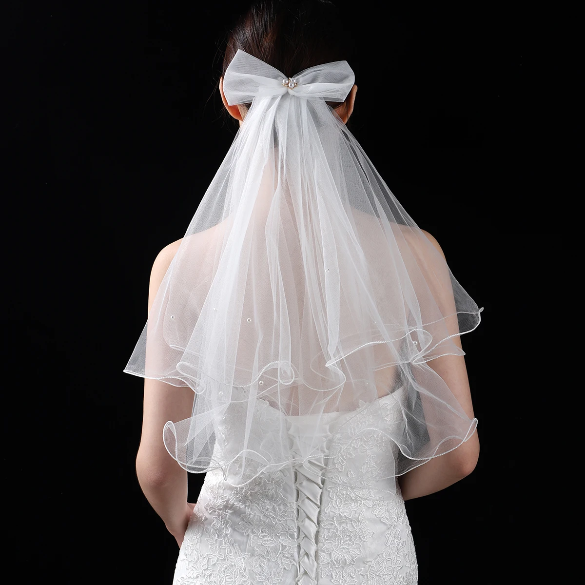 A white elegant bridal veil adorned with a bow, suitable for women's wedding waist length veils