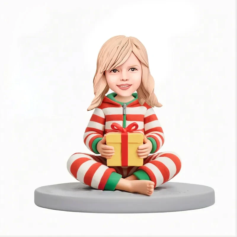 Custom Child in Striped Pajama Set Sitting While Holding Gift Box Custom Bobblehead With Engraved Text Gift