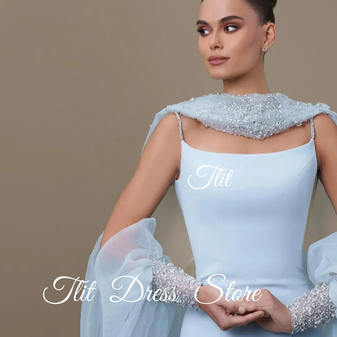 فستان سهرة أنيق من TLIT باللون الأزرق والحرير والساتان حورية البحر مع سترة من التول وأكمام منتفخة وقطار سويب كريستالي مع كريستالفساتين
