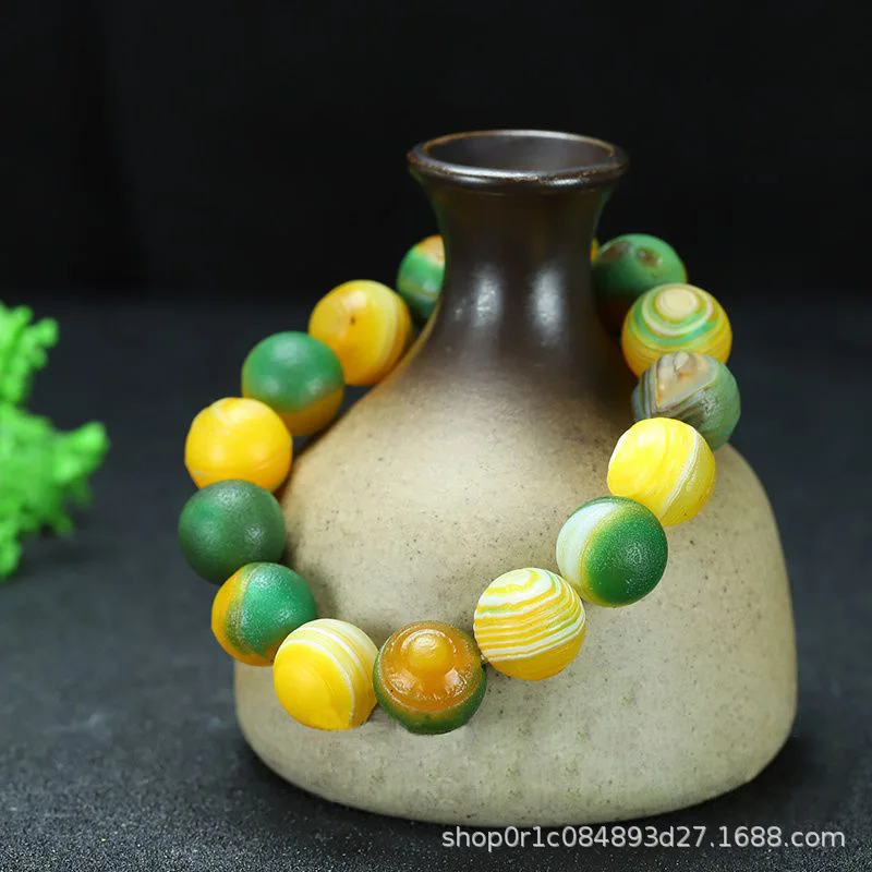 

Antique-style yellow-green agate bead with eye and pharmacist beads, vintage accessory bracelet