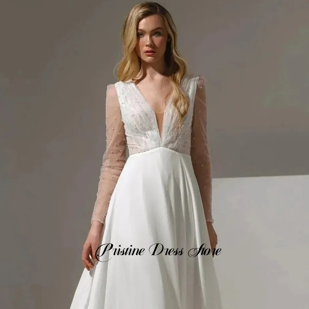 فستان زفاف رومانسي من الشيفون واللؤلؤ بأكمام طويلة مخصص بطيات عميقة على شكل حرف v بطول الأرض مع مشد