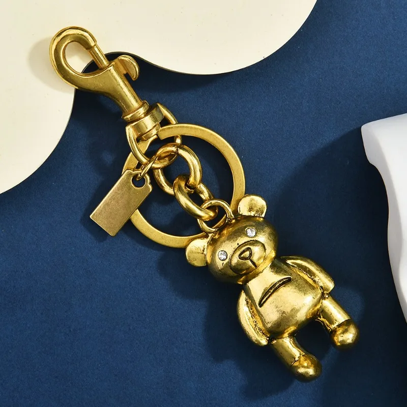 

2026 DIY Золотистый брелок-подвеска для автомобильных ключей и сумок, украшение для школьного рюкзака: медведь, вишня, четырехлистный клевер, бабочка