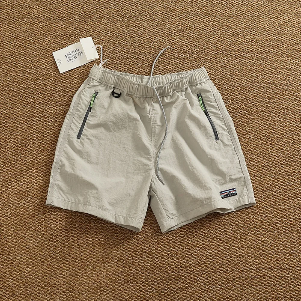 กางเกงขาสั้นแห้งเร็วกลางแจ้งฤดูร้อนสําหรับกางเกงกลางกางเกงแบรนด์แฟชั่นถนนสูงของผู้ชาย