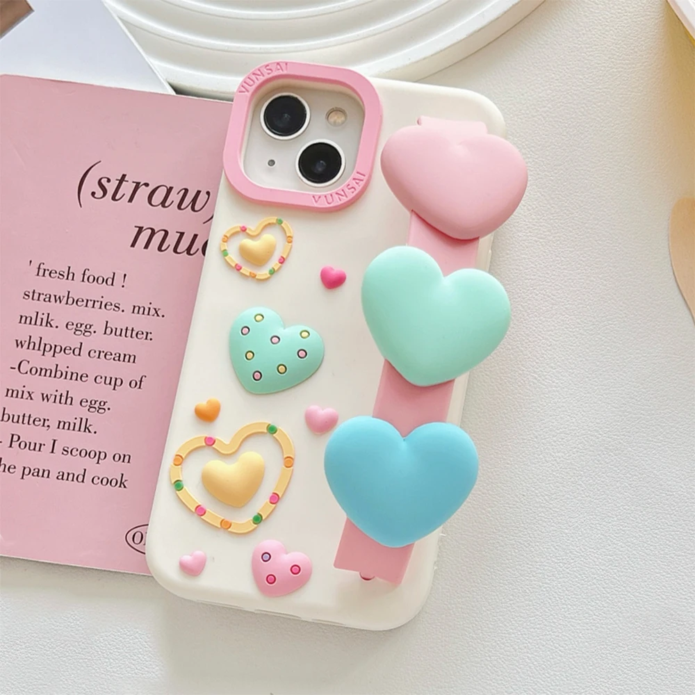 

3D Cute Heart Cartoon Love Wristband Wrist Strap Phone Case for iPhone 17 16 15 14 13 Pro Max Soft Shockproof Cover Case