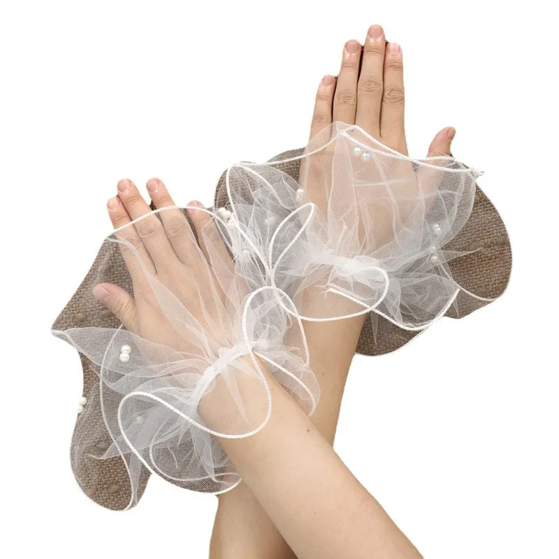 A short pearl tulle roll-up edged beaded bridal glove for a summer wedding ball party worn elegantly with fingerless sleeves