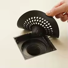 Hair catcher in bathroom sink with water flow
