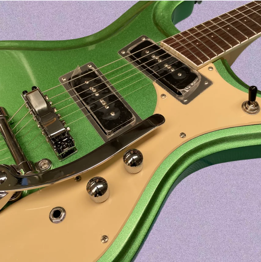 Bright green 6-string electric guitar with vintage vibrato systemguitars, a collector's favorite retro electric guitarra