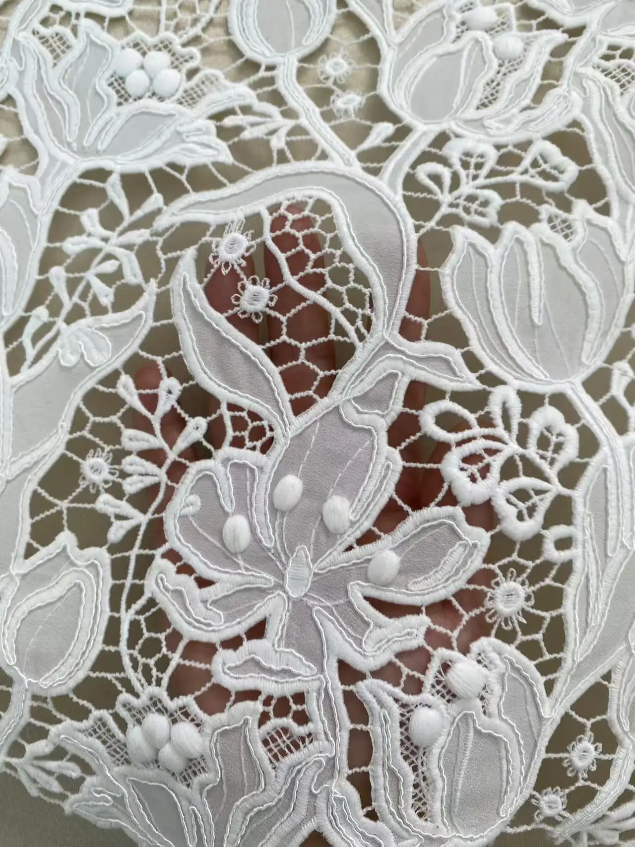 Elegant White Embroidered Lace Fabric for Weddings - Intricate floral patterns with delicate 3D embellishments, creating a dream