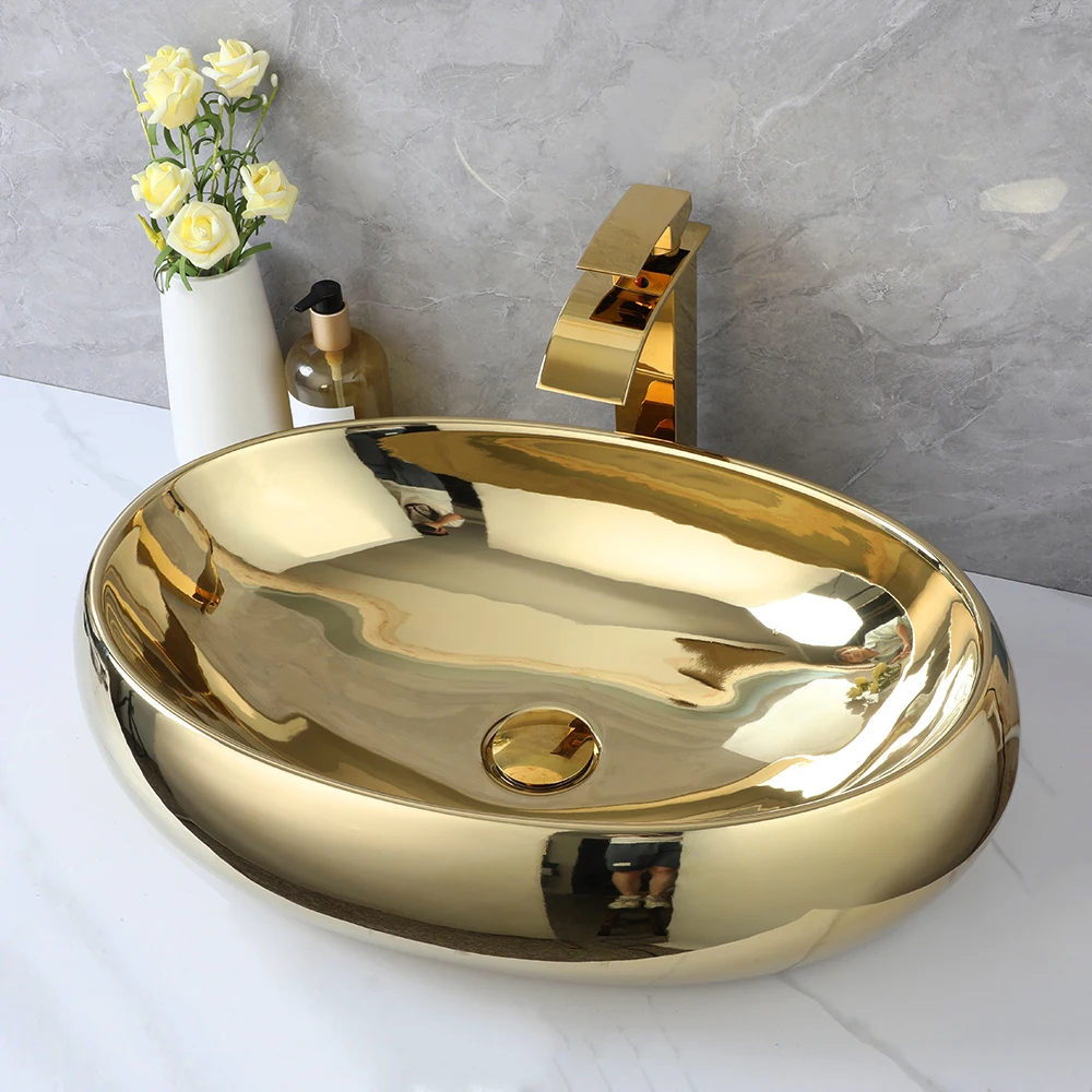 ZAPPO 23 Inch Bathroom Vessel Sink Gold Ceramic Sink Bowl Above Counter Oval Bathroom Sink with Waterfall Faucet Drain Combo