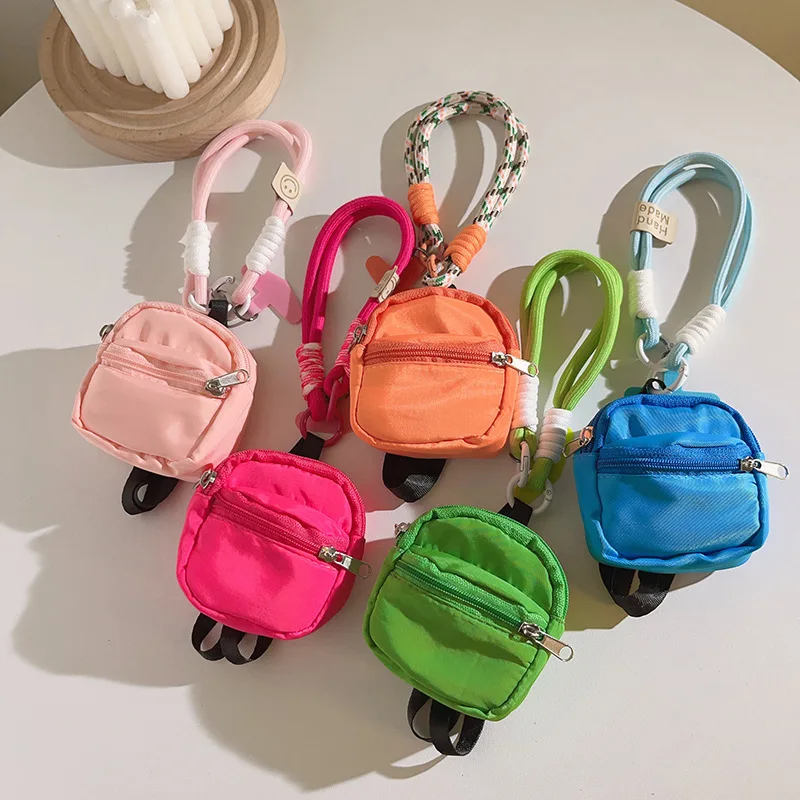 Small schoolbag pendants, mobile phone lanyards, mini coin purses, Bluetooth storage bags, hand-held pendants, universal