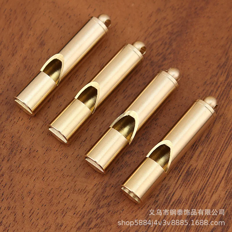 Brass keychain pendant, featuring a dragon head design, a smooth, polished finish, and a bamboo-style copper whistle, su