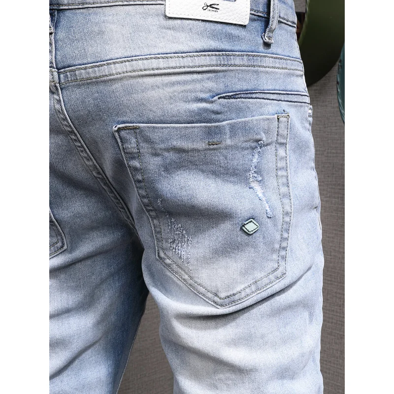 Light colored casual jeans for men, slim fit with small feet and elastic Korean style trendy and versatile casual ripped pants
