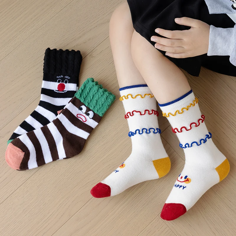 

Children's socks in three pairs, spring and autumn style, with cute ruffles and smiling faces for boys and girls