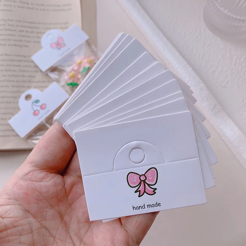 50 stücke Kirsche/Bogen Knoten/Blumenmuster hängende Karte 6,4x4cm faltbare Tag für Haarschmuck Verpackung Schmuck Einzelhandel Preis schild