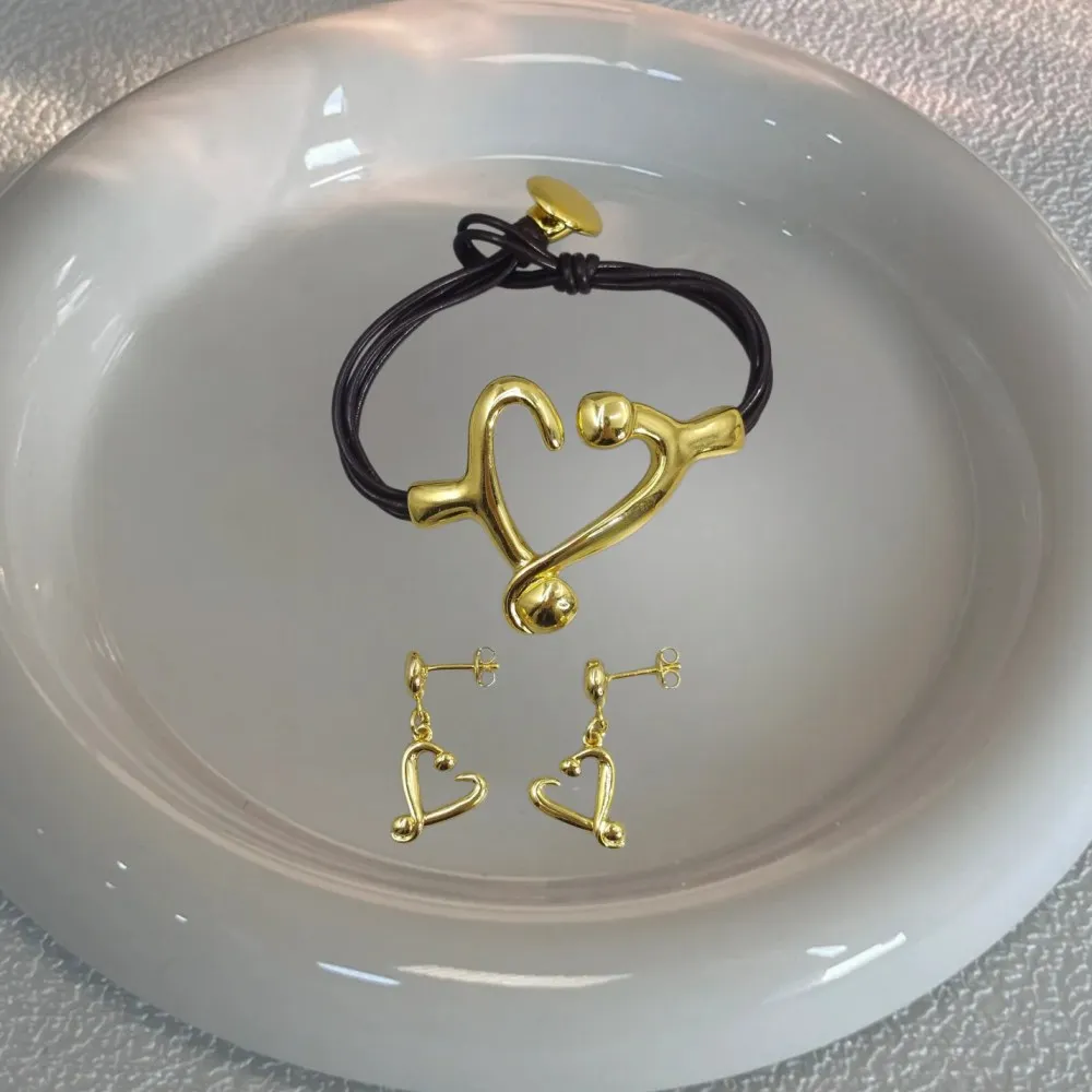 2026 Spain Cute Fashion Gold and Silver Heart Earrings Leather Rope Bracelet Jewelry Two Piece Set Party Gift
