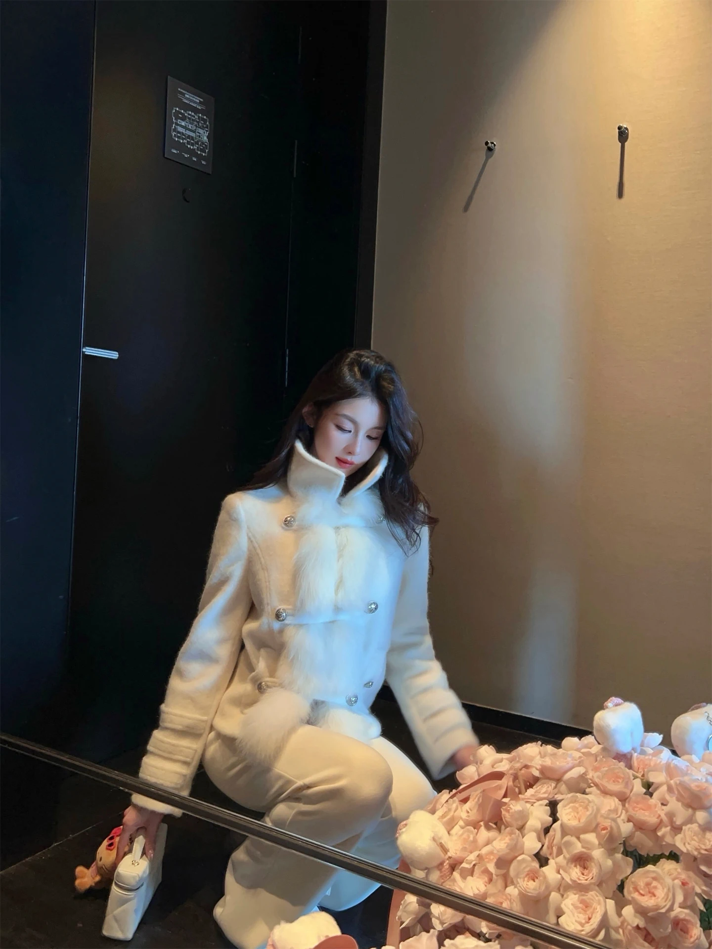 A short women's coat with a down lining and woolen fabric, made of genuine fox fur, high-necked white mink fur