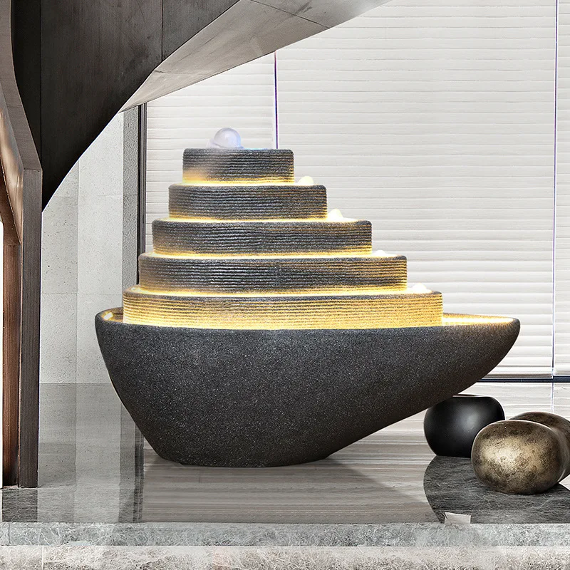 Fountain flowing water landscape ornament, under the stairs of the company's front desk, modern decoration in the hotel lobby