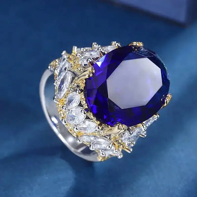 Huitan Luxuriöser zweifarbiger Damenring, wunderschöner eleganter Party-Schmuck für Damen, mit glänzendem blauem ovalem Zirkonia besetzt, edler Modeschmuck, Geschenk