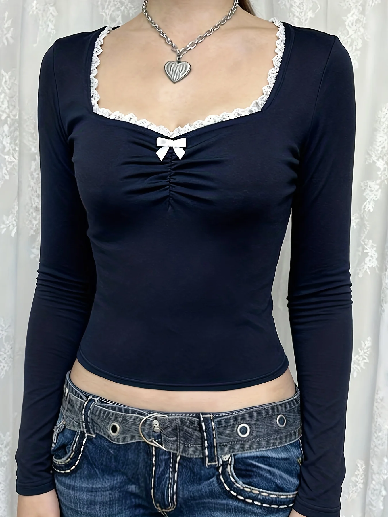 A beautiful and charming chest-hugging T-shirt in royal blue with a white lace collar and bow decoration