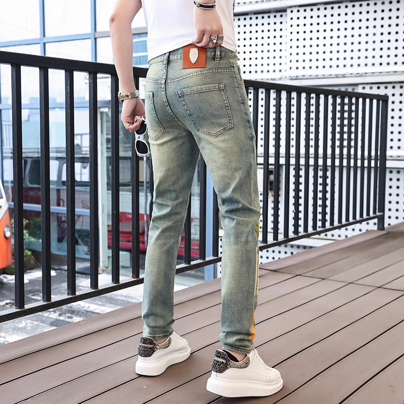 Personalized street fashion pumpkin print men's jeans 2024 spring and summer trend retro casual elastic slim tapered pants