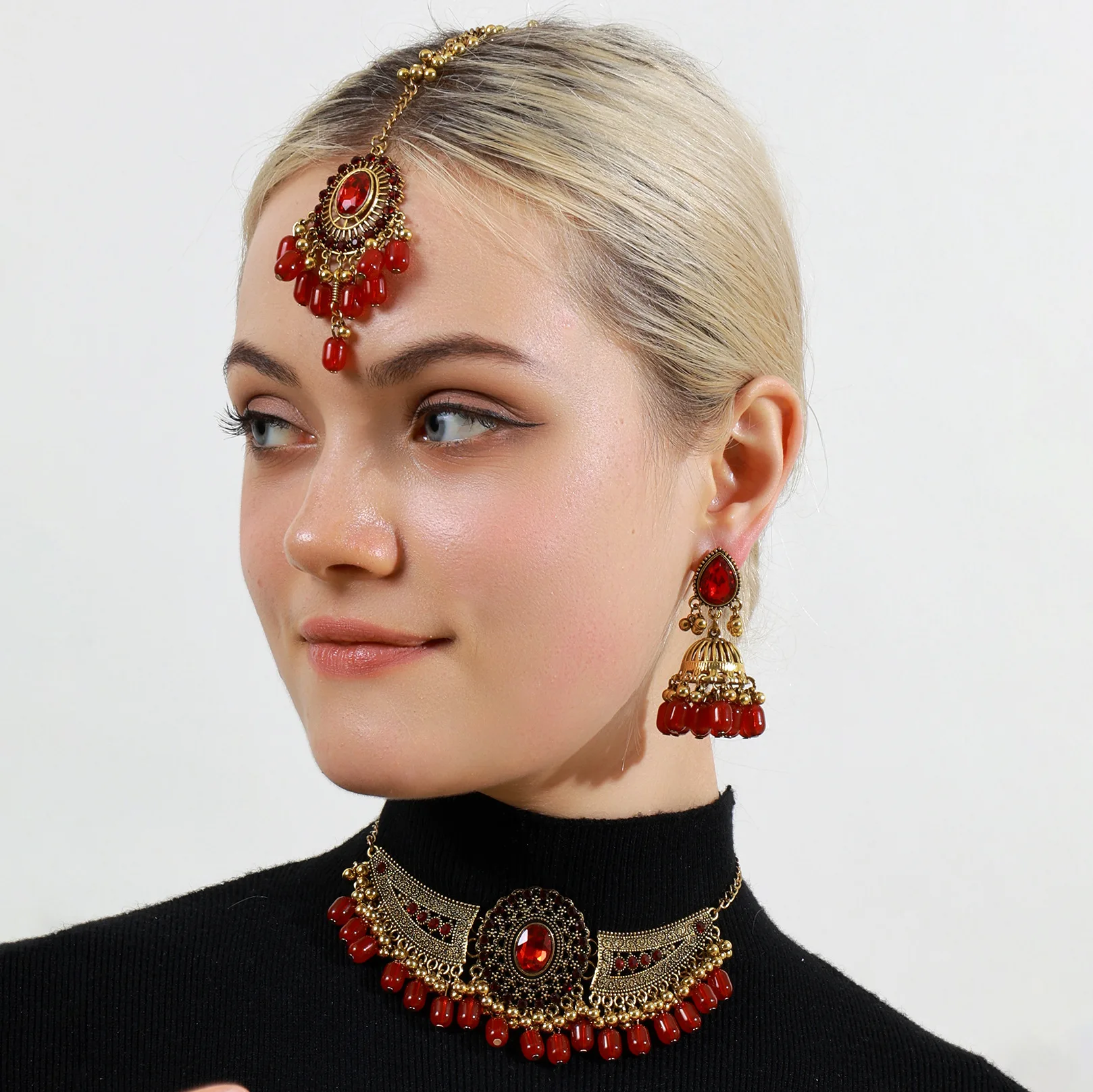 

Indian bride's three-piece set: diamond and gemstone tassel head chain, metal wing tassel necklace, and earrings with headwear