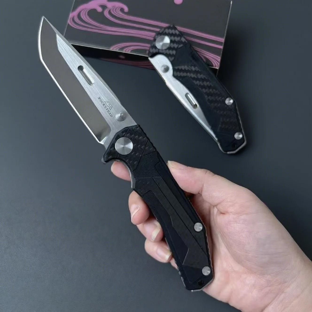 

Rockstead - A fully handcrafted folding knife, featuring a carbon fiber and G10 composite handle, and a portable pocket knife