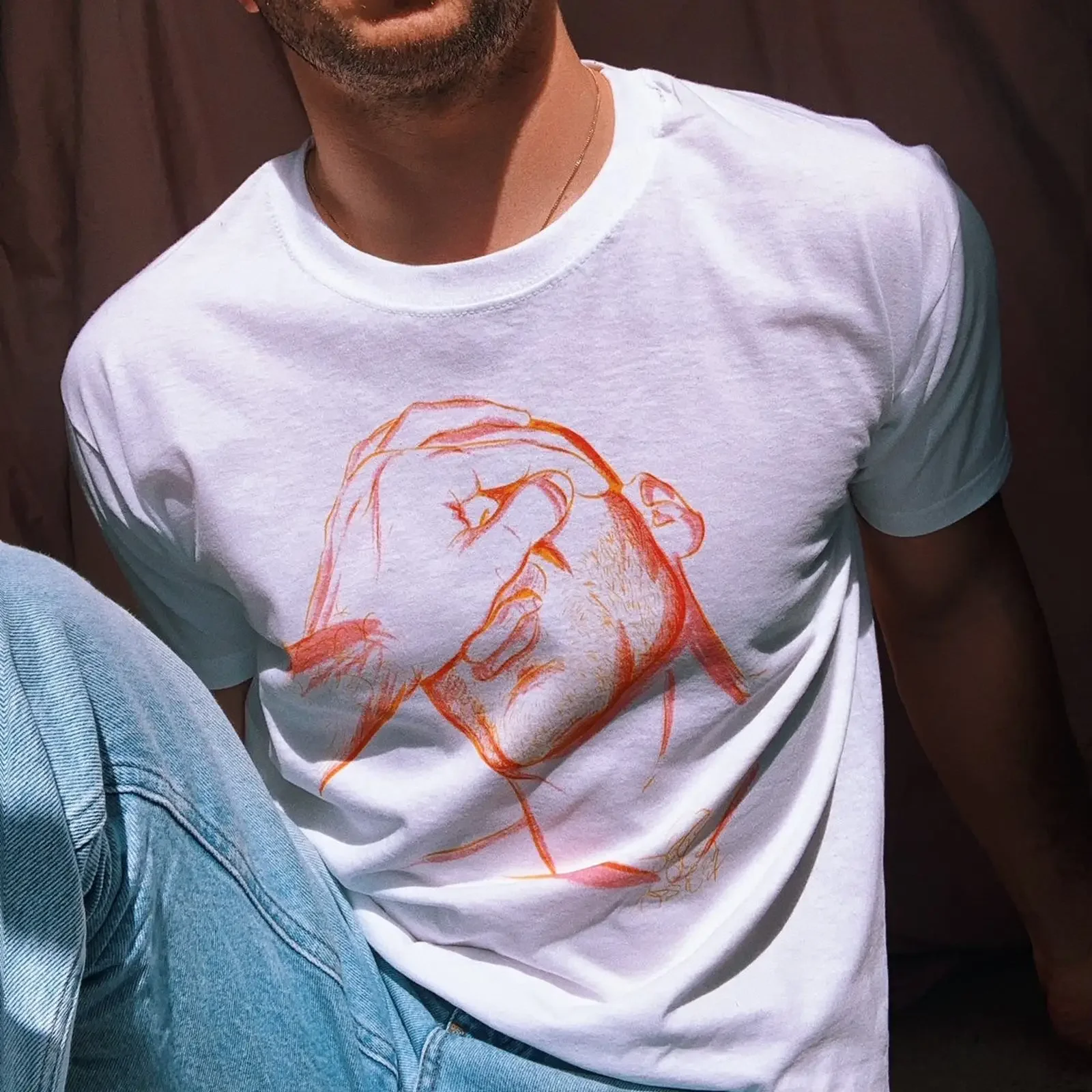 May include A white t shirt with red and orange illustration of person's face hand covering their eyes vintage Washed Casual