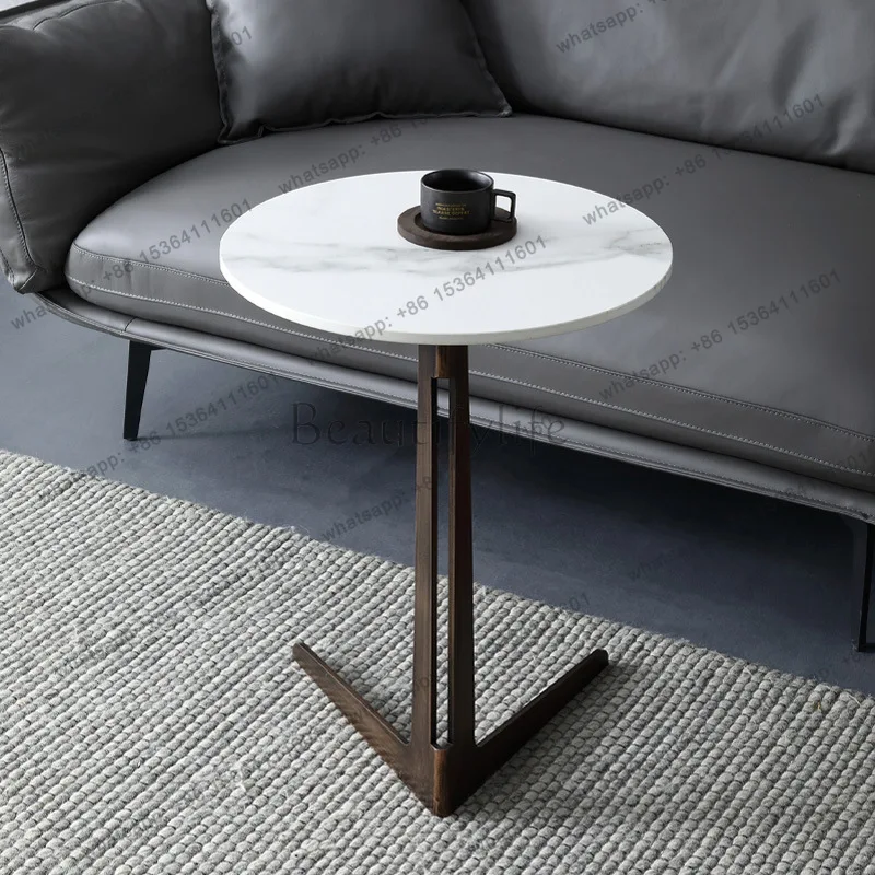 Italian minimalist rock slab sofa next to a few modern round countertops mini coffee table