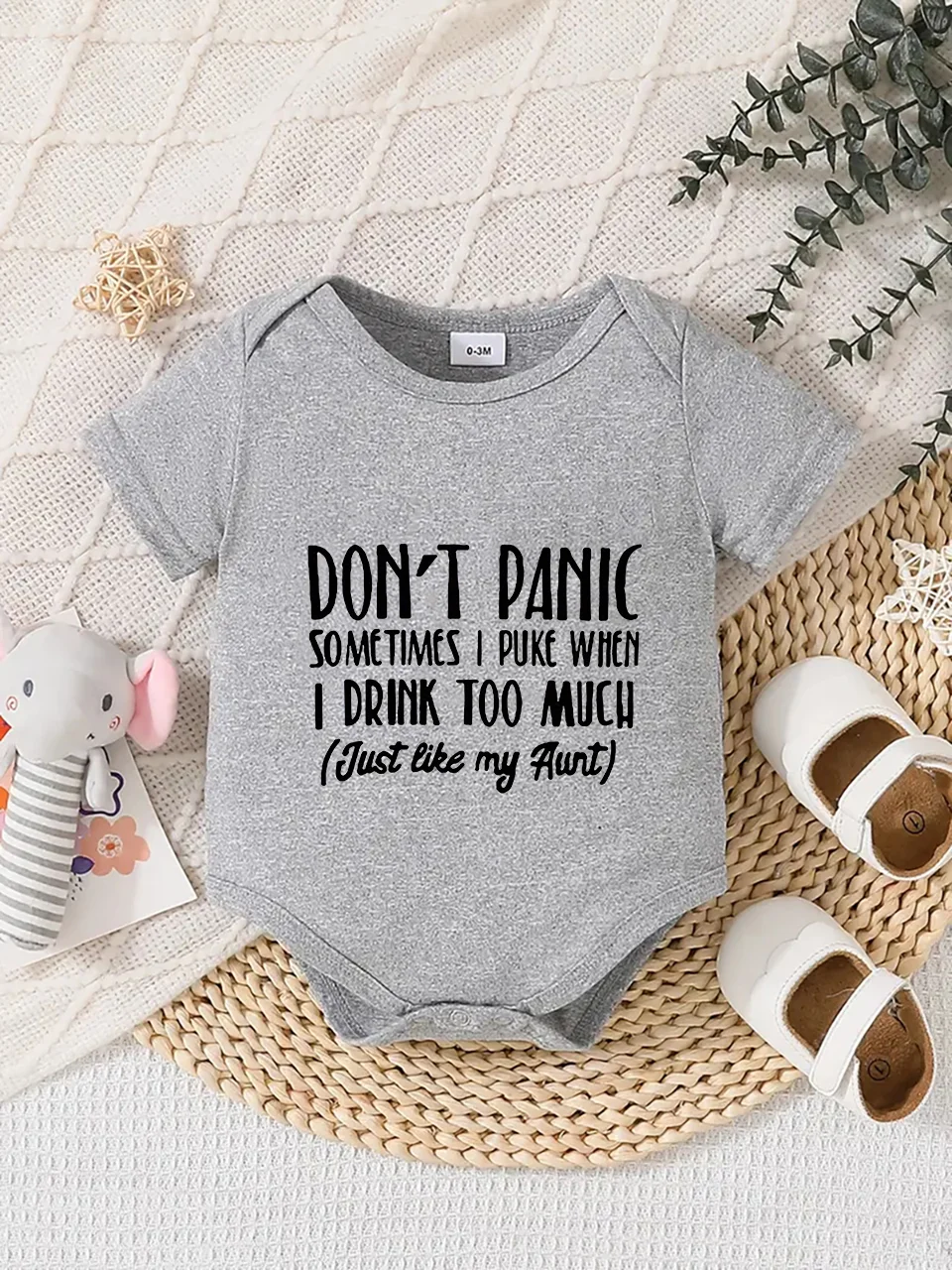 Playful letter-printed baby short-sleeve triangle bodysuit. Button closure for easy dressing, machine washable