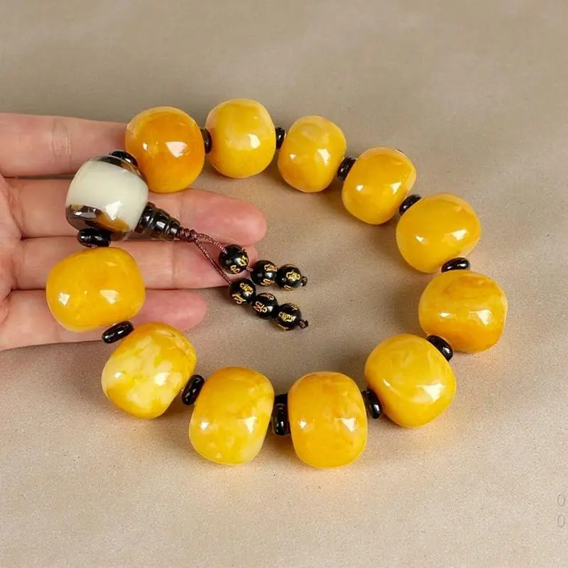 Yellow amber bracelet with black separator beads and pendant