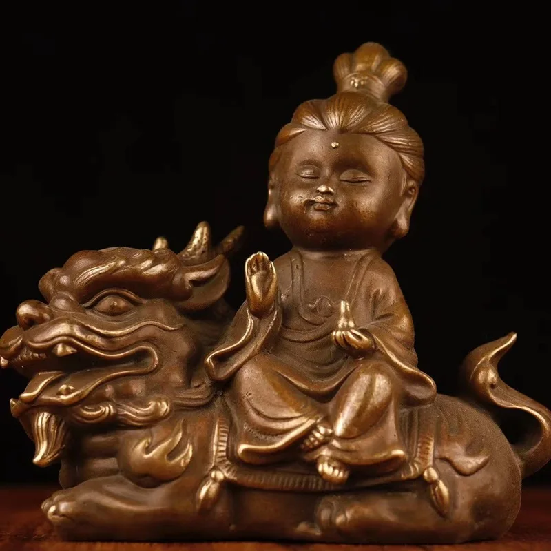 Vintage antique collectible copper statue of Guanyin sitting on a beast, home decoration gift ornament with a rich patina