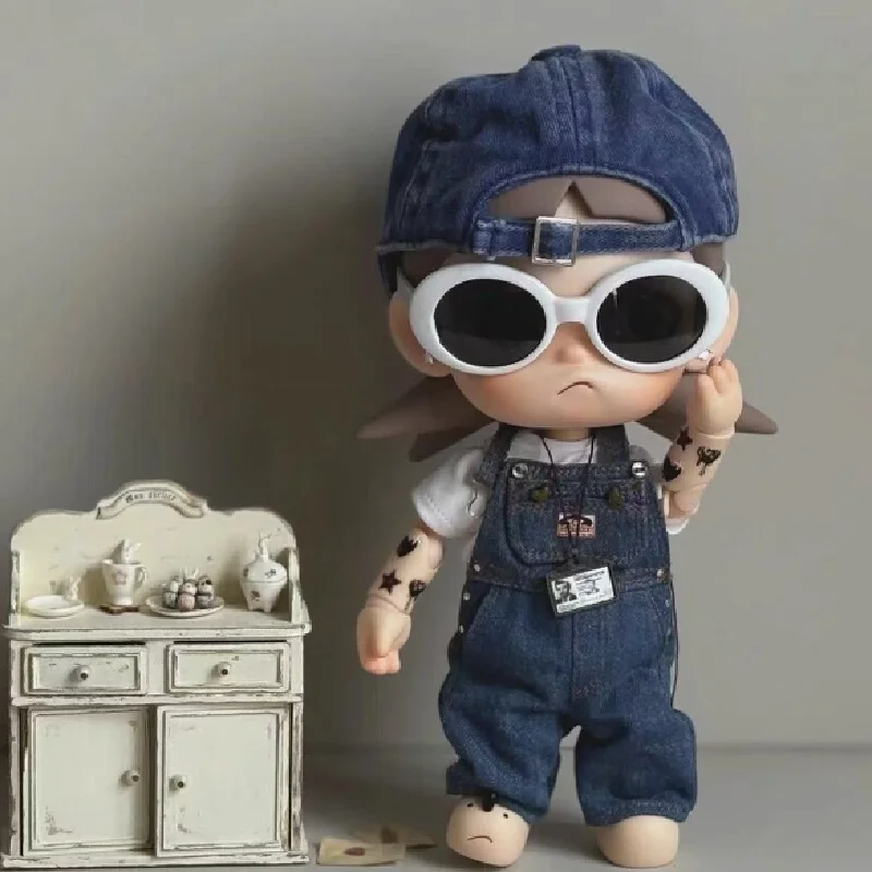 

This is a doll-like outfit for Zsiga. It features a jacket a skirt a pair of sunglasses and a pair of jeans with drawstring p