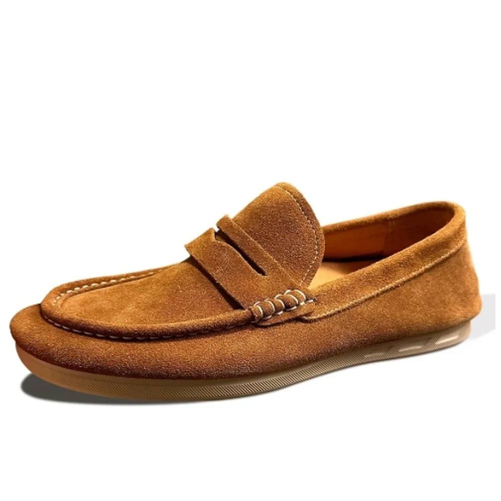 Men's brownish-yellow suede loafers, hand-stitched with a flat sole for a casual style.