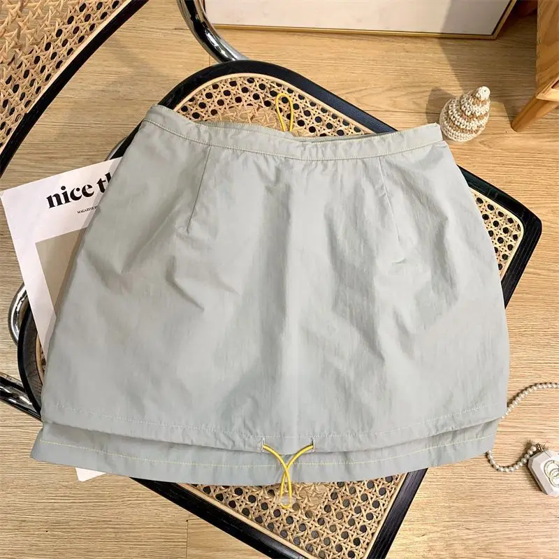 Light green short skirt women's new thin drawstring design in the summer of 2024, sporty and casual Joker A-word hip skirt.