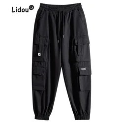 Juventude moda cor sólida vários bolsos calças de carga homem novo solto cintura drawcord casual all-match masculino calças 2023